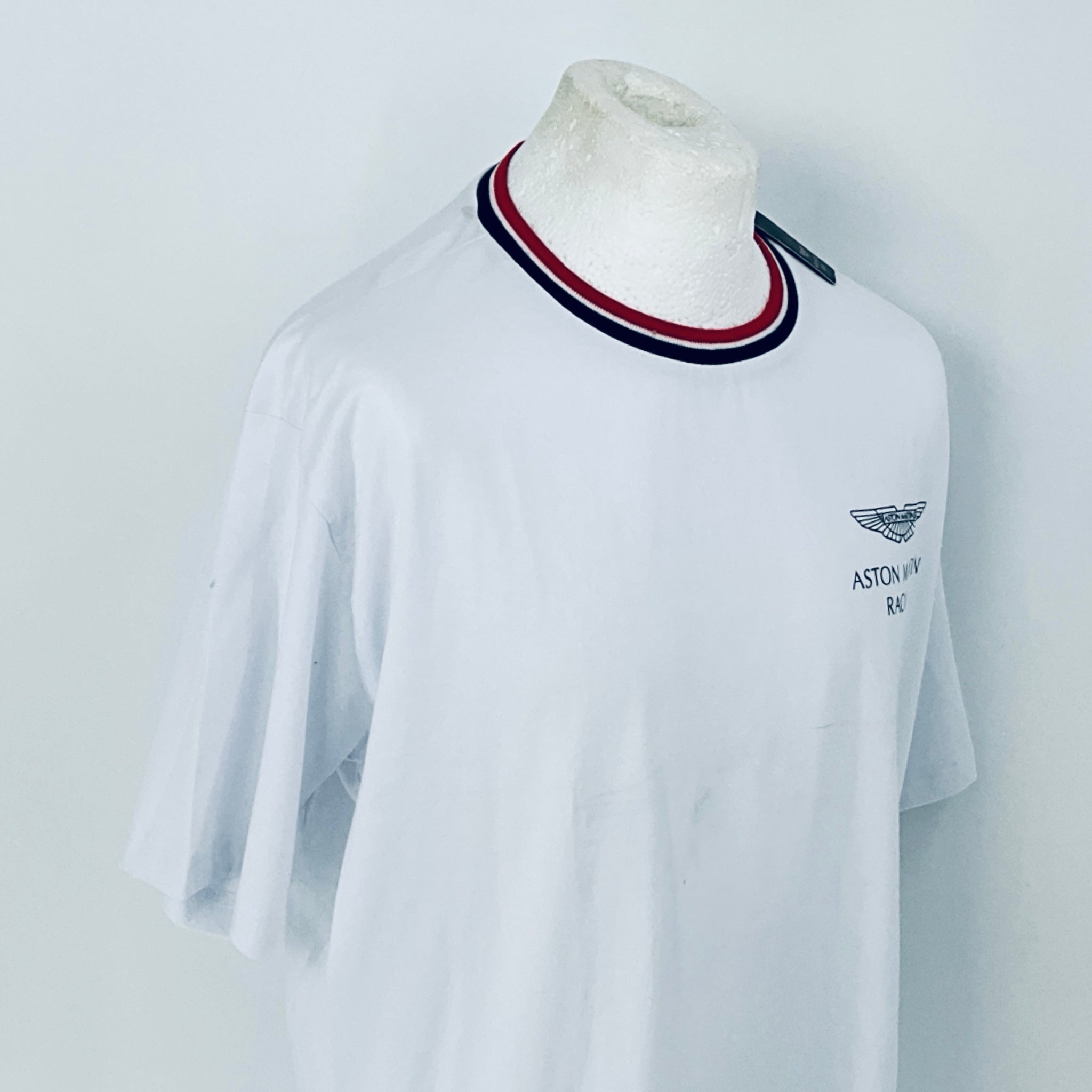 White t-shirt with a logo on a mannequin against a light gray background