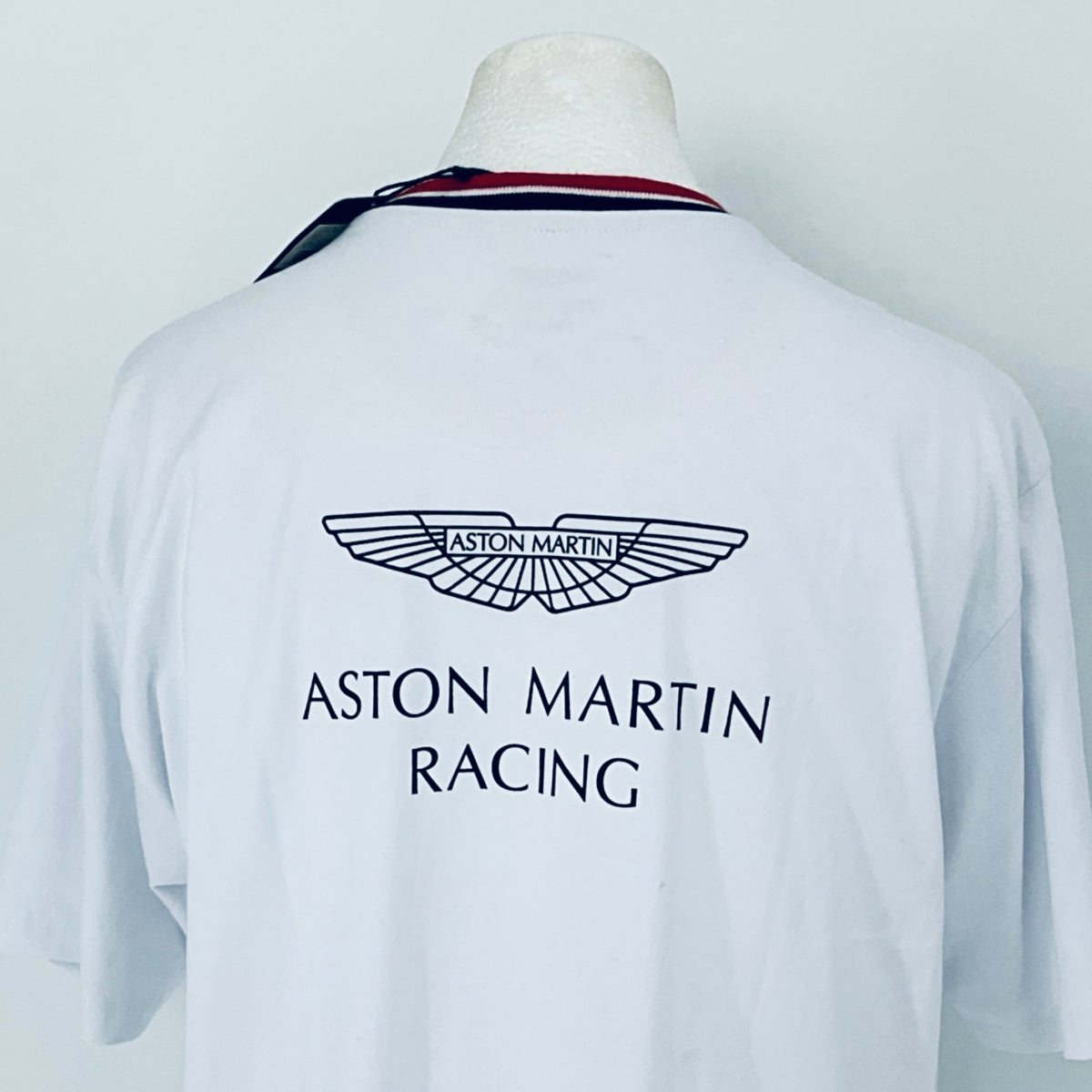 White shirt with Aston Martin Racing logo on a mannequin against a white background