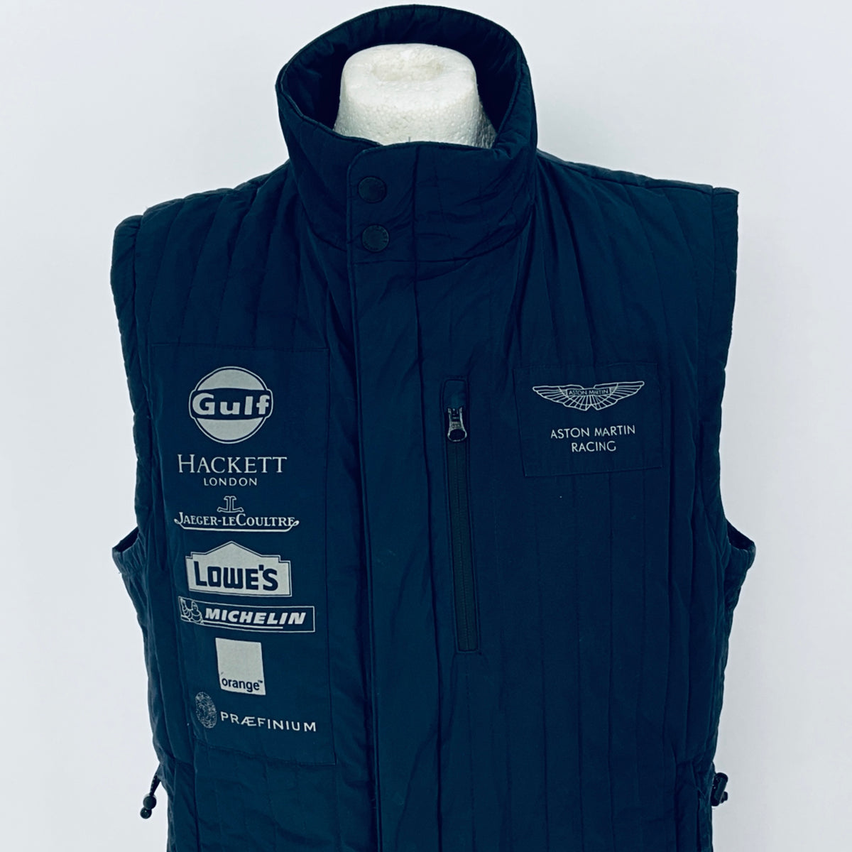 Navy blue vest with various brand logos on a white background