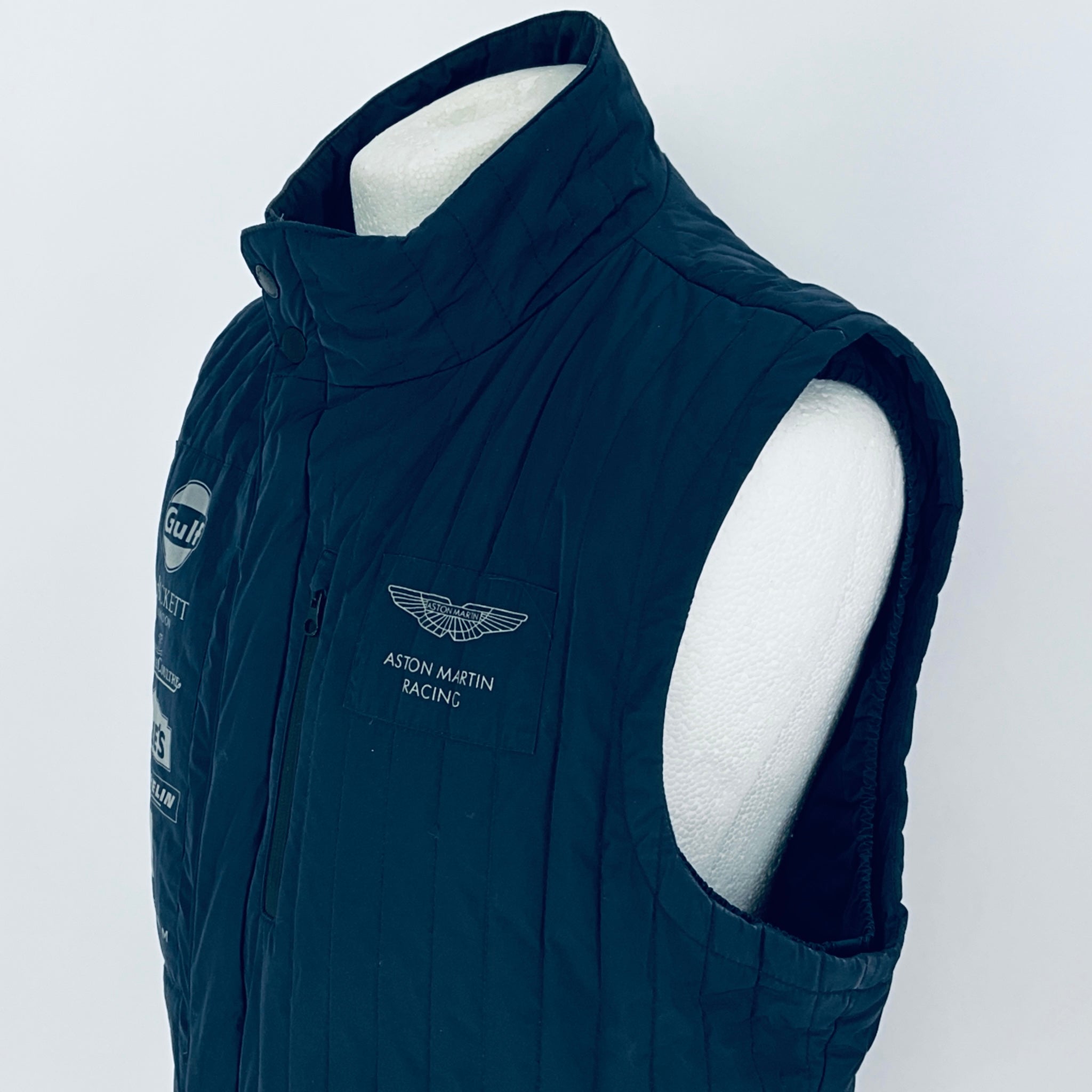 Navy blue vest with branding on a white background