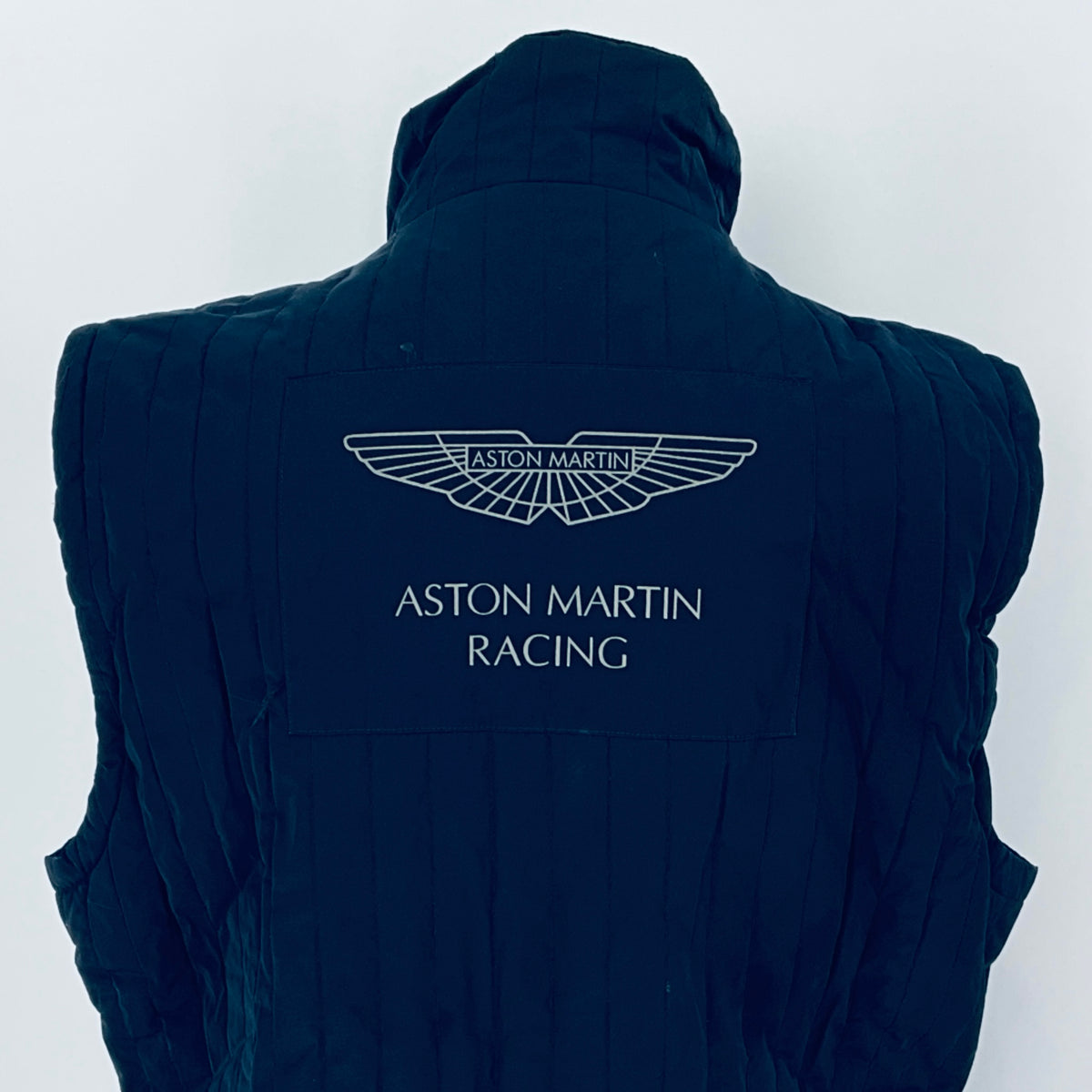 Navy blue vest with Aston Martin Racing logo on a white background