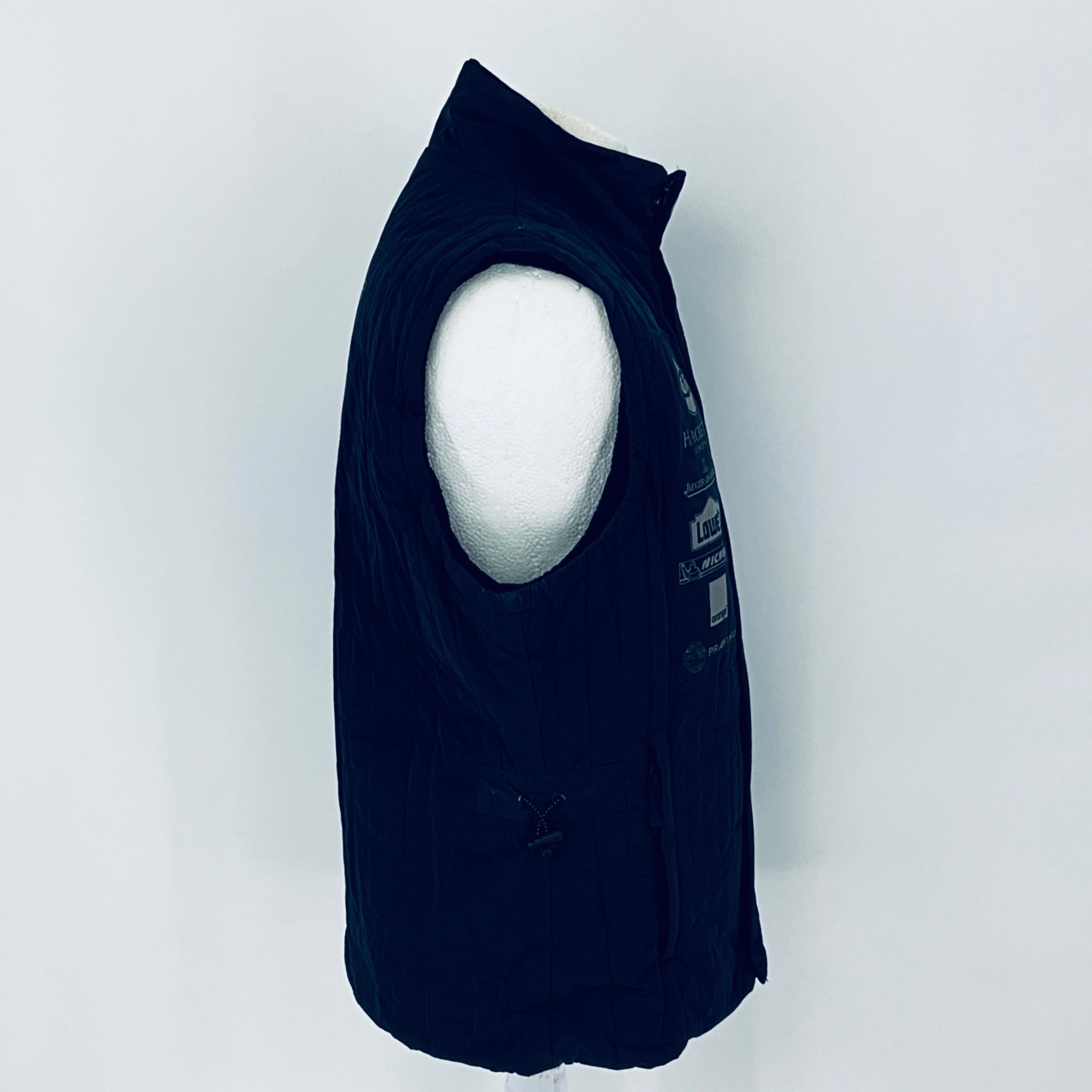Black sleeveless jacket on a mannequin against a white background