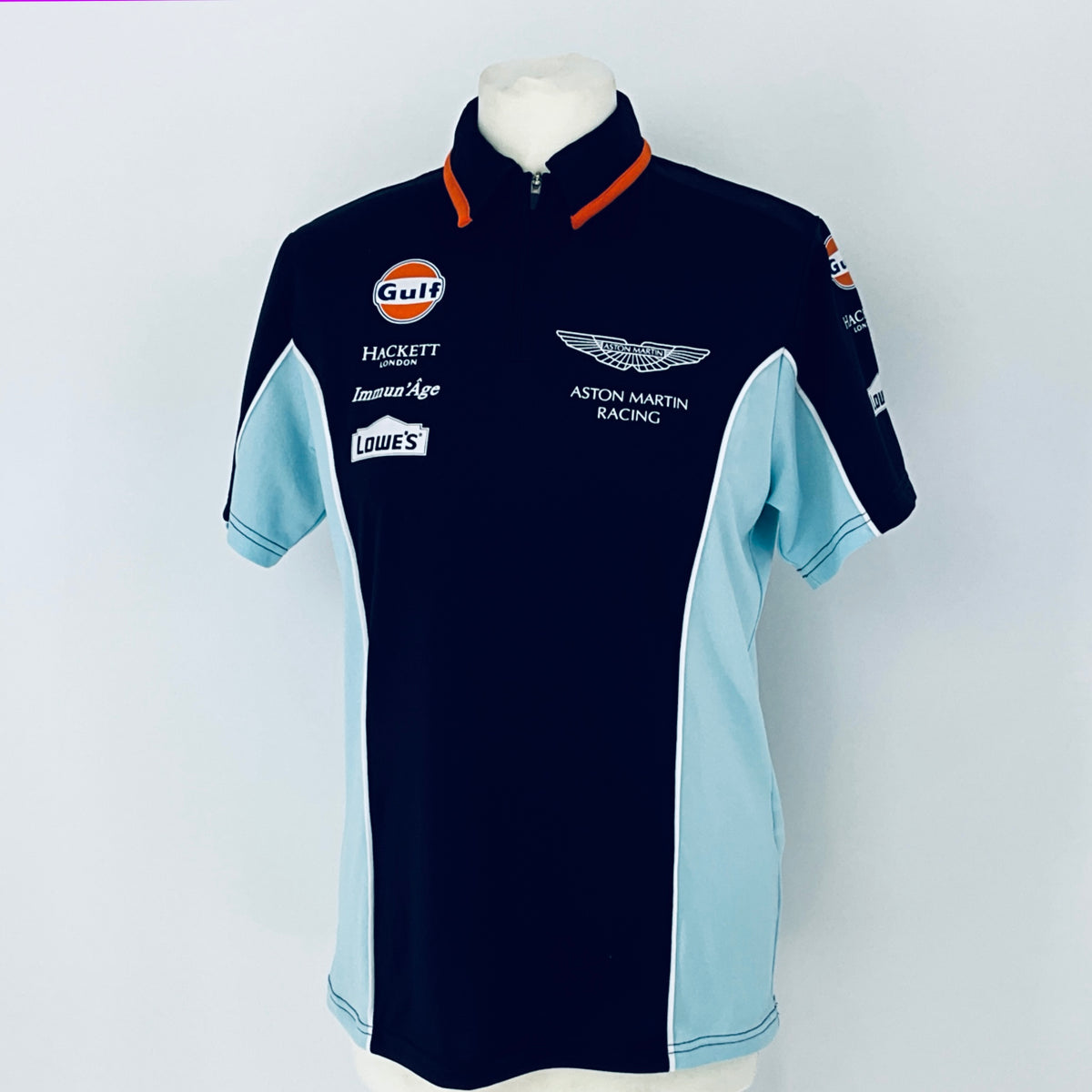 Navy and light blue racing shirt with various sponsor logos on a white background