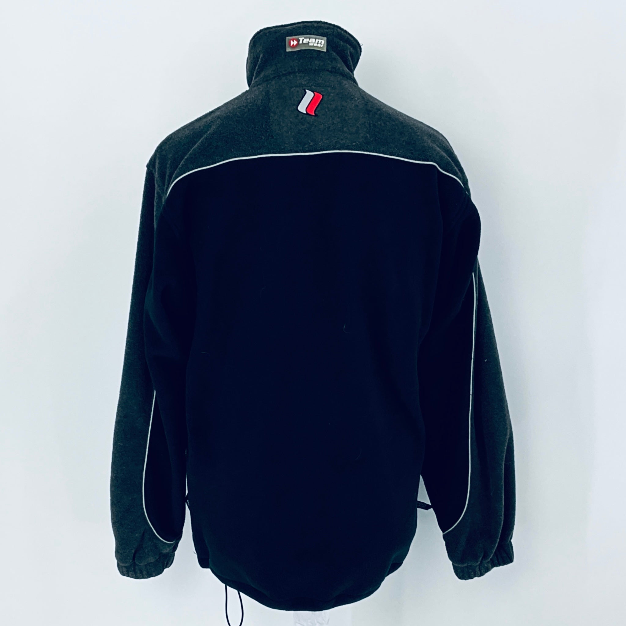 Black fleece jacket with a brand logo on the chest against a white background