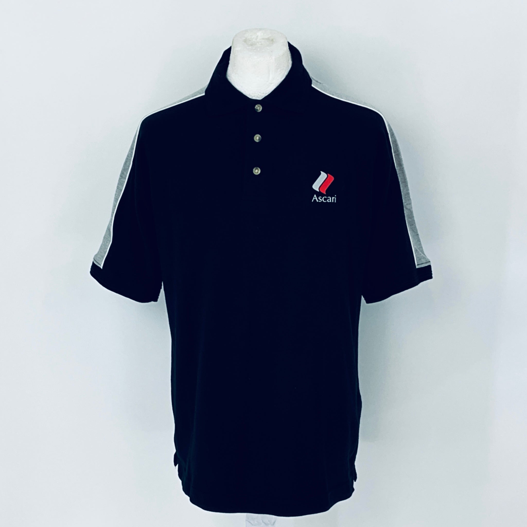 Black polo shirt with a logo on a mannequin against a white background