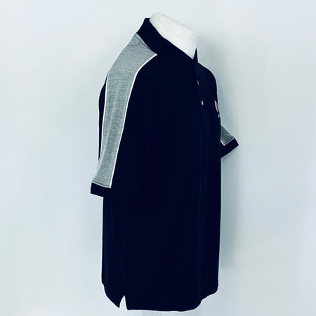 Black polo shirt with gray accents on a mannequin against a white background