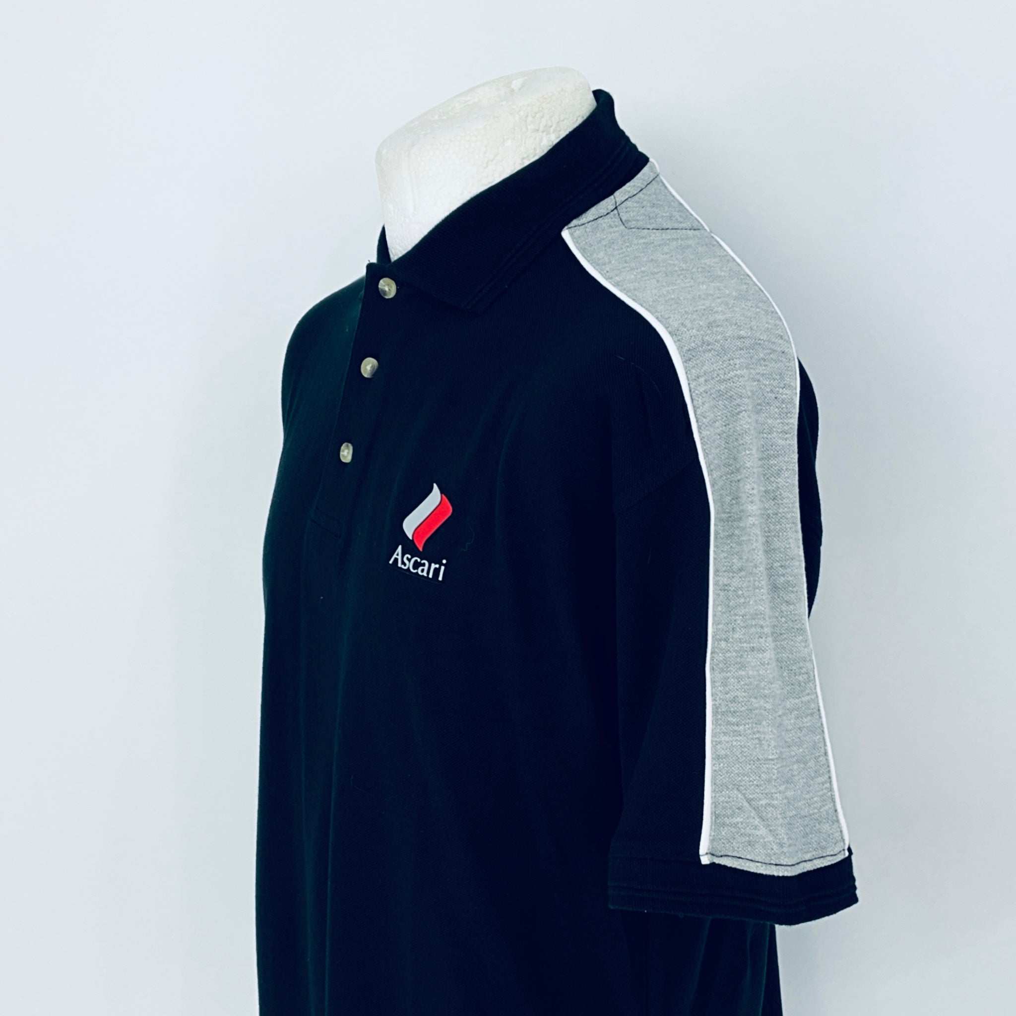 Navy polo shirt with gray sleeves on a mannequin against a white background