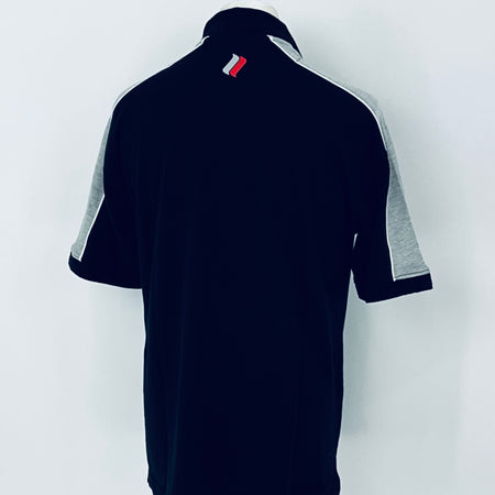Black polo shirt with gray sleeves on a white background