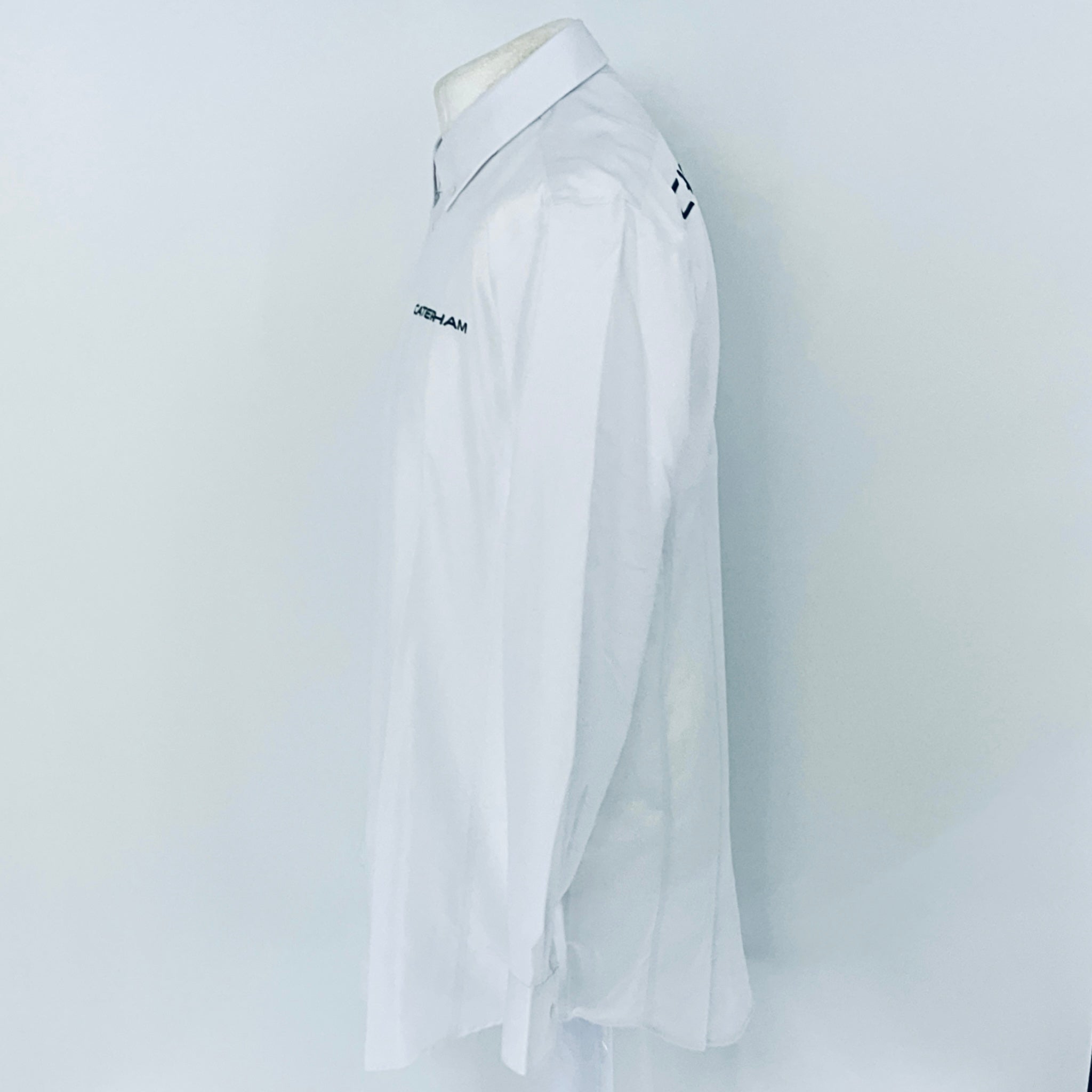 White shirt with brand logo on a mannequin against a white background