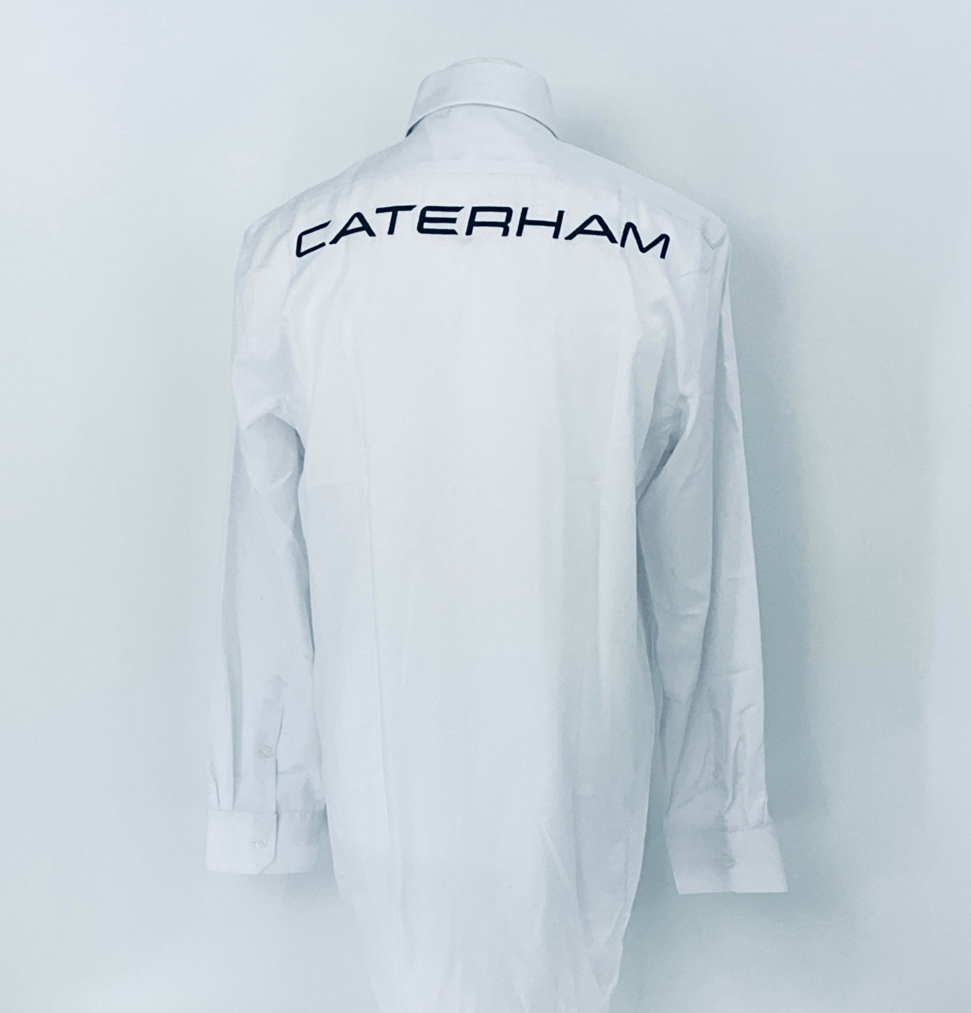 White shirt with 'Caterham' logo on the back against a white background