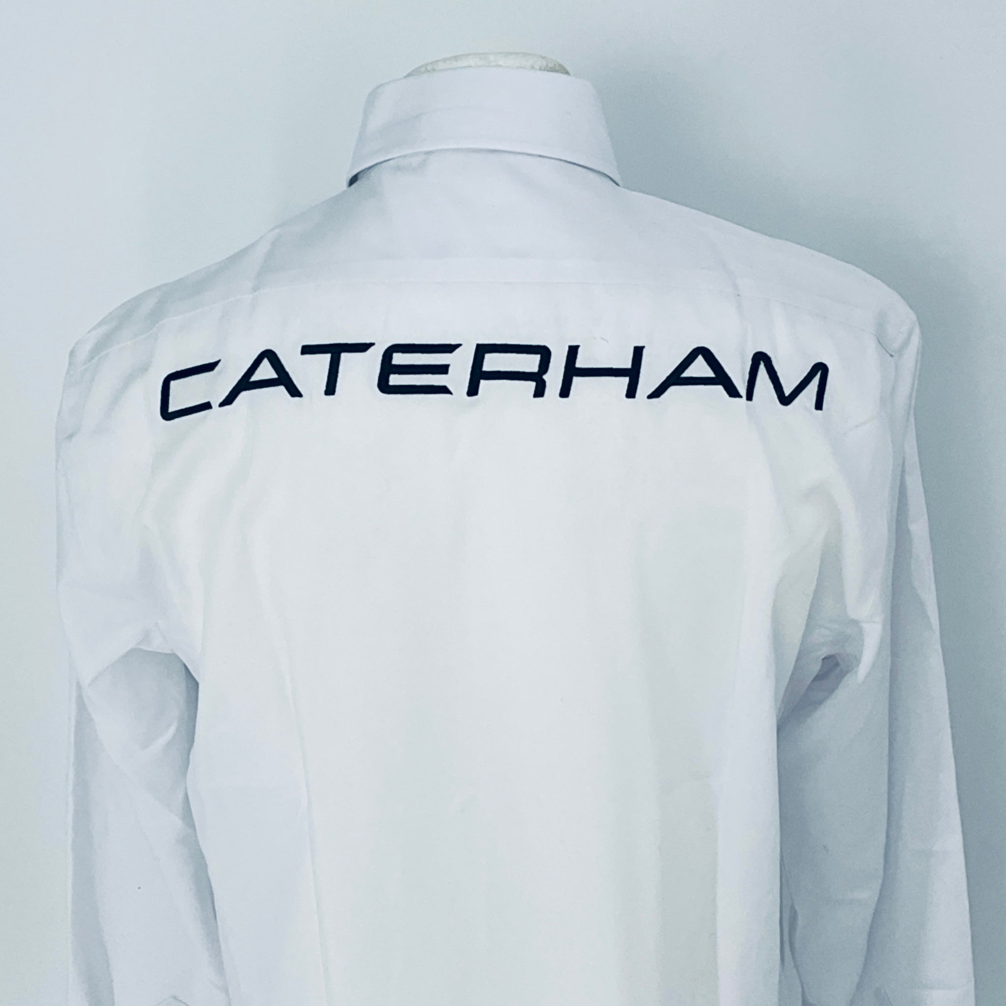 White racing suit with 'Caterham' branding on a plain background