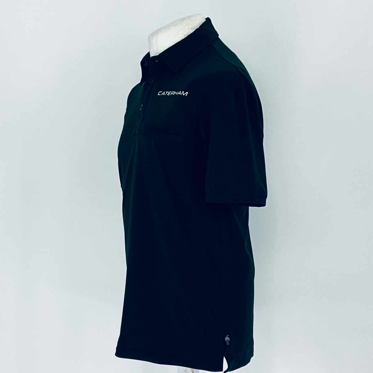 Black polo shirt on a mannequin with 'Caterpillar' branding against a white background