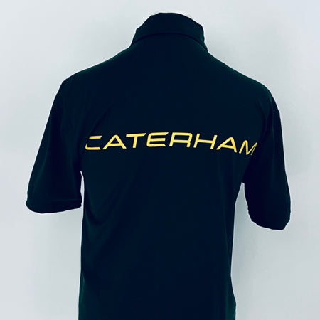 Black polo shirt with 'Caterham' logo on the back against a white background