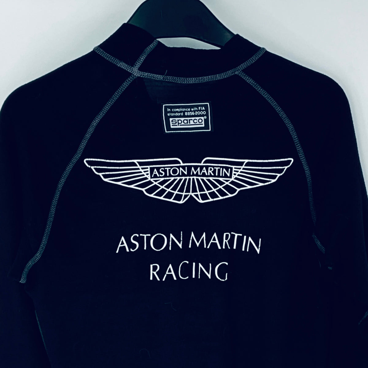 Navy blue shirt with Aston Martin Racing logo on a white background
