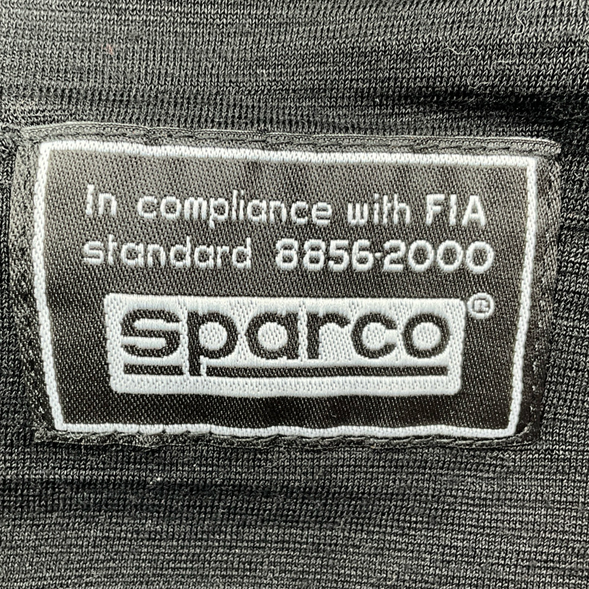 Sparco label on a black background with FIA compliance text