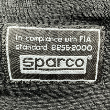 Sparco label on a black background with FIA compliance text