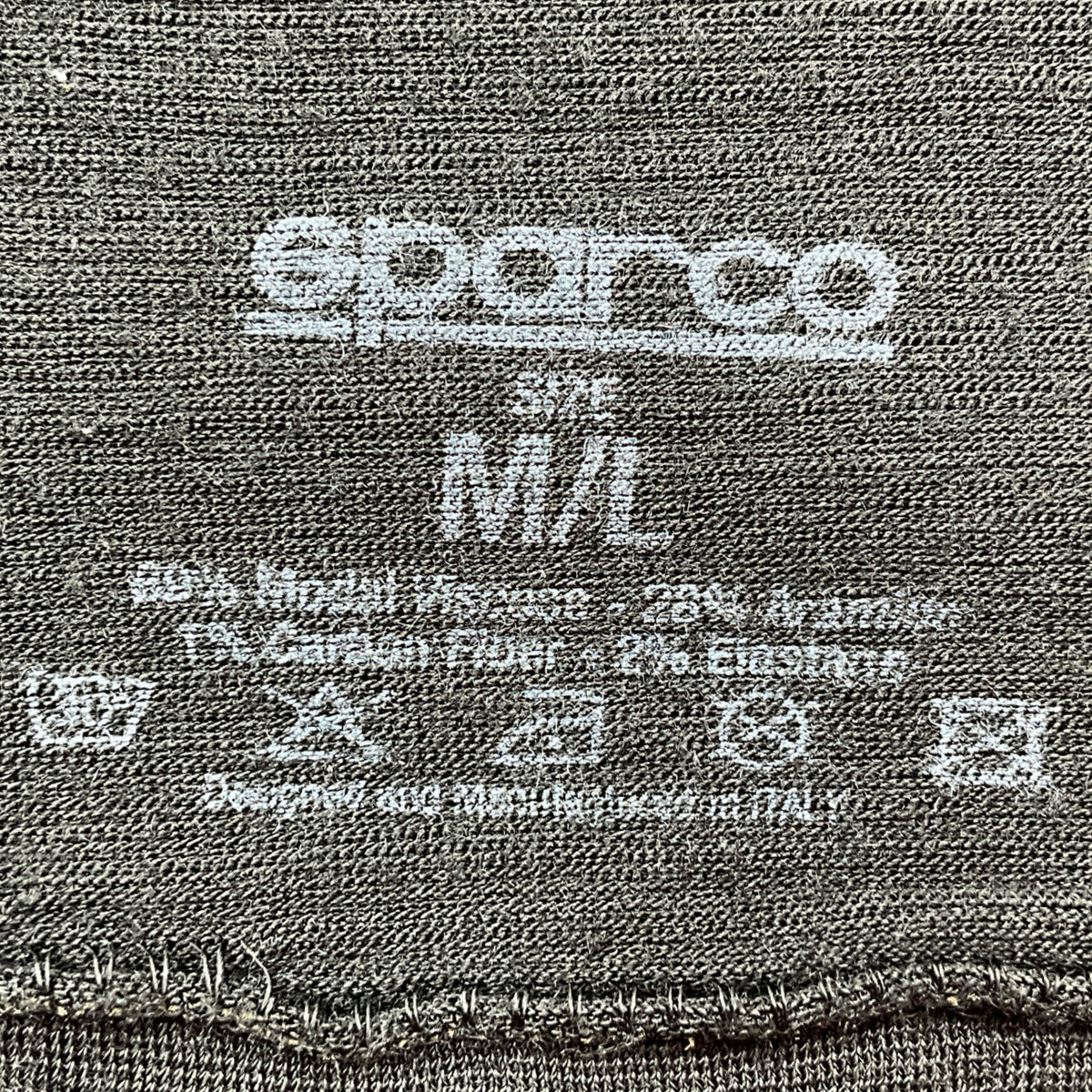 Close-up of a label on a fabric with 'Superio' branding and size information.
