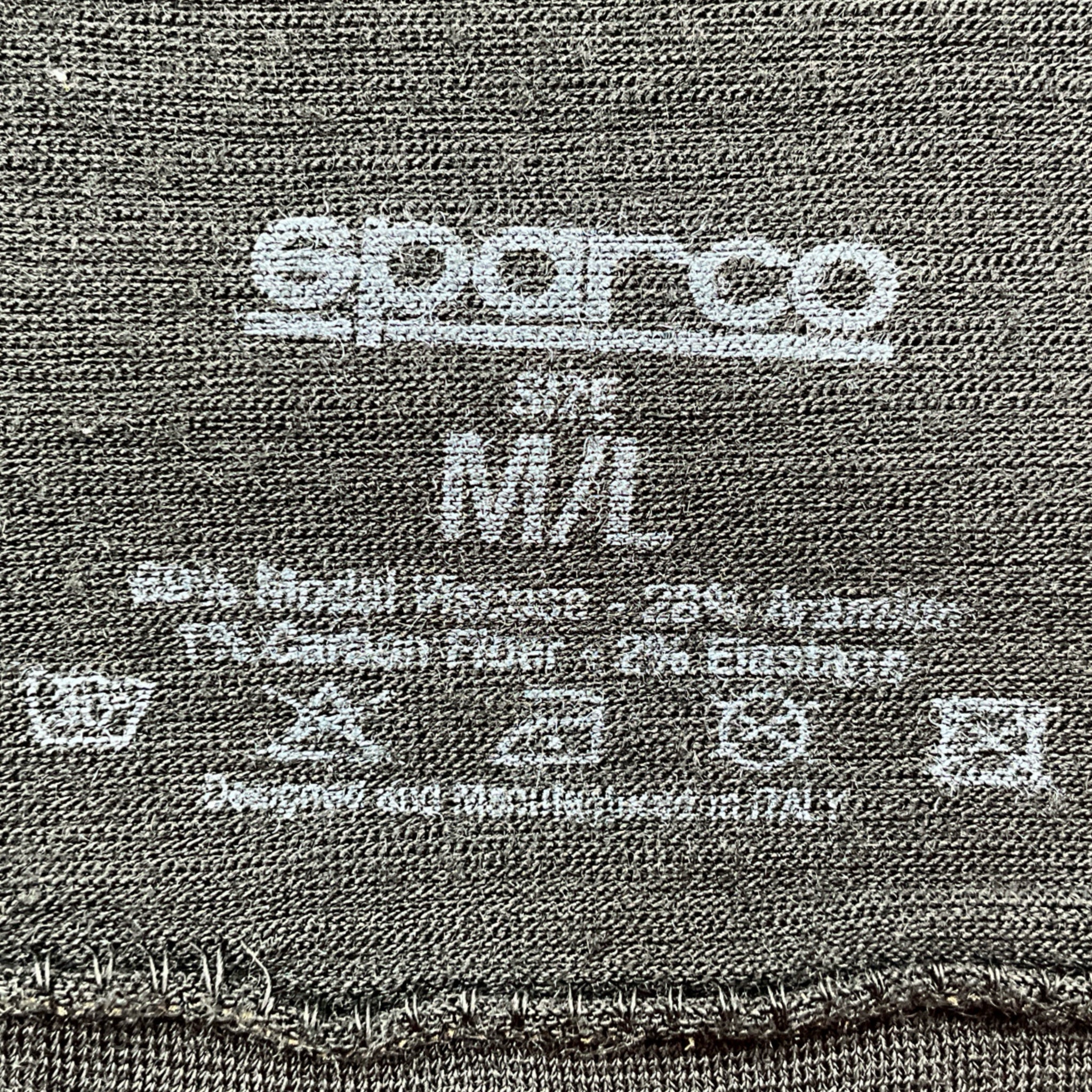 Close-up of a label on a fabric with 'Superio' branding and size information.