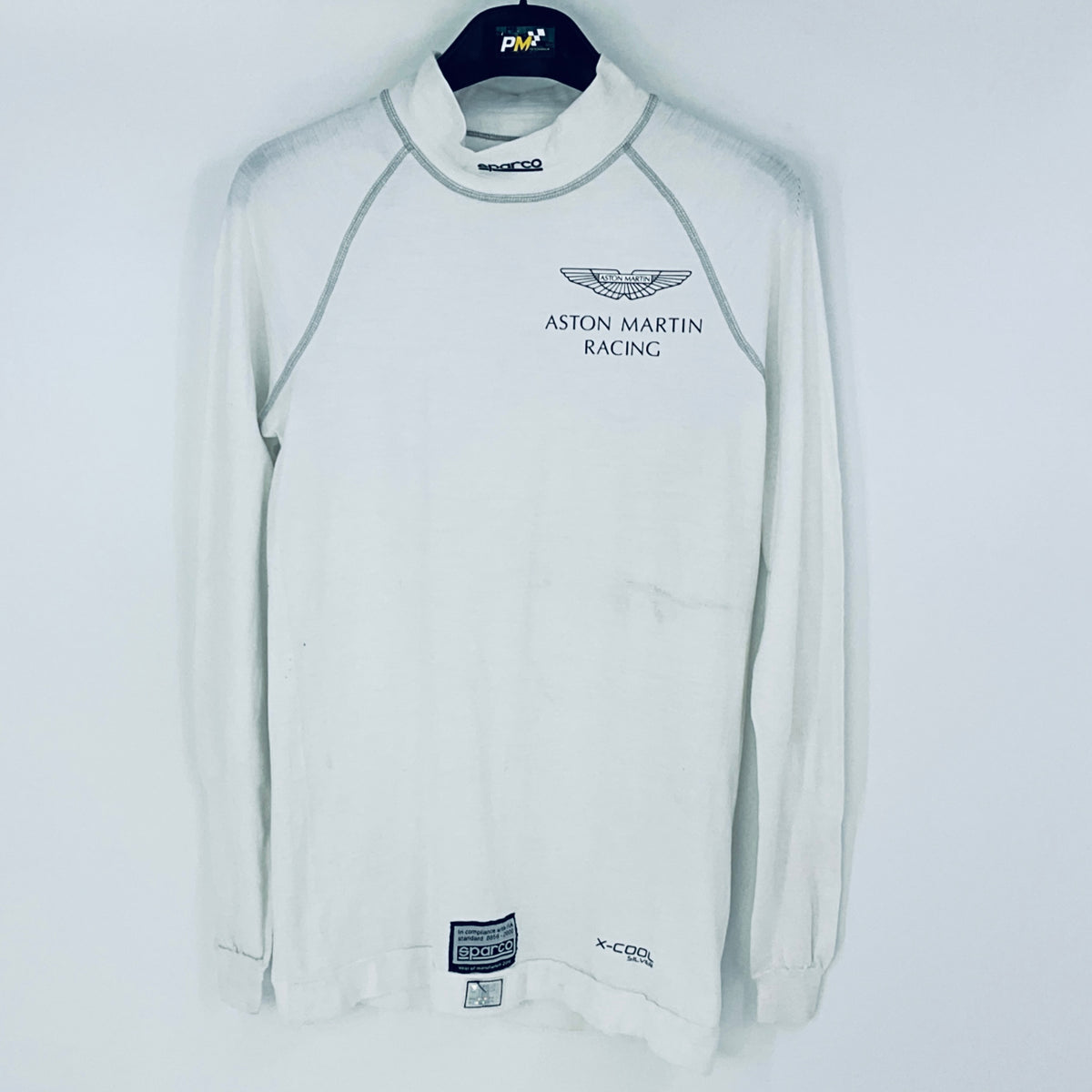 White long-sleeve shirt with Aston Martin Racing logo on a white background