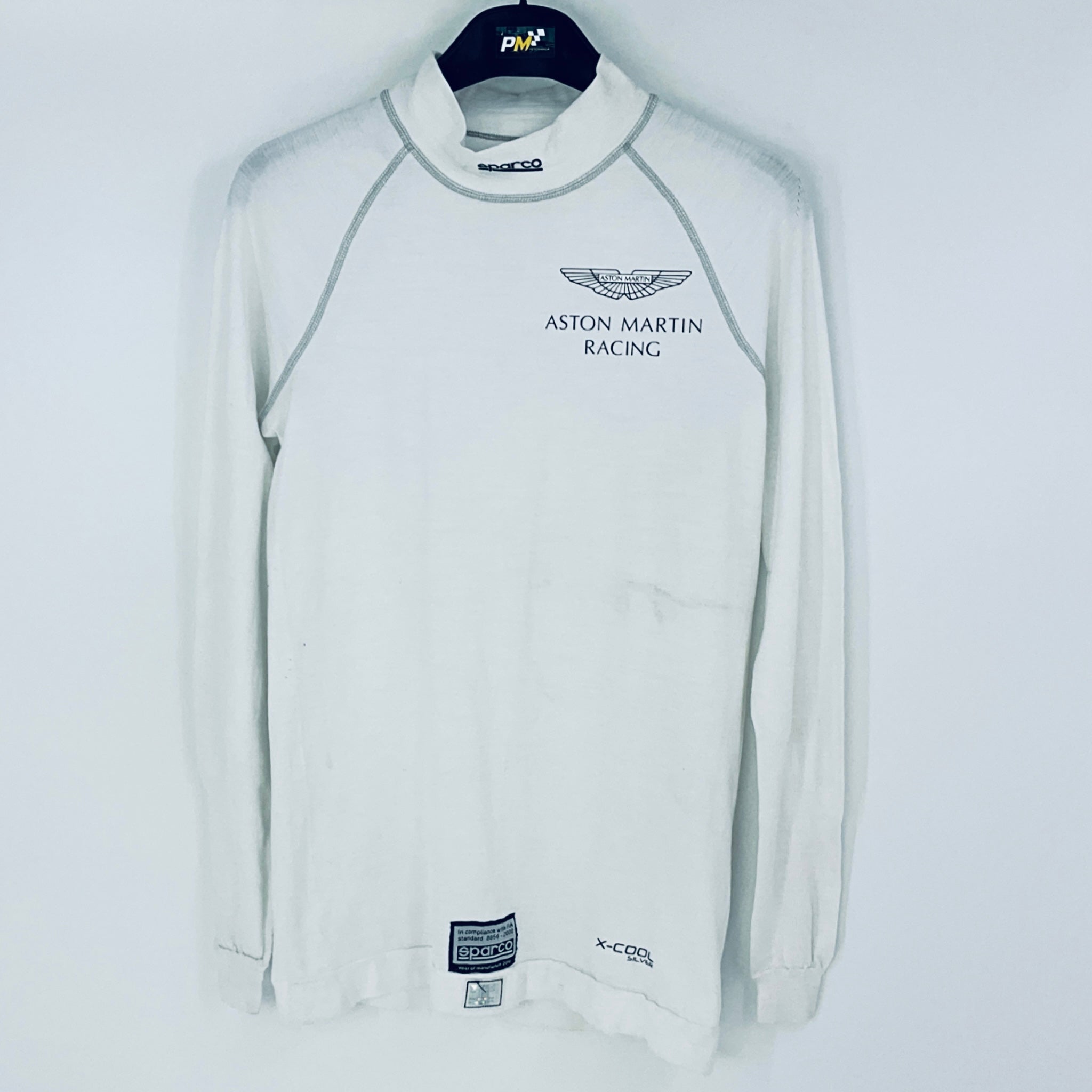 White long-sleeve shirt with Aston Martin Racing logo on a white background