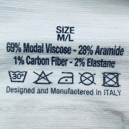 Textile label with material composition and care instructions on a fabric background