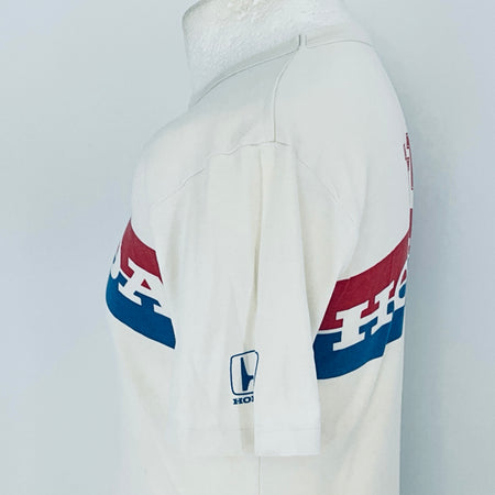 White hoodie with red and blue logo on sleeve against a light gray background