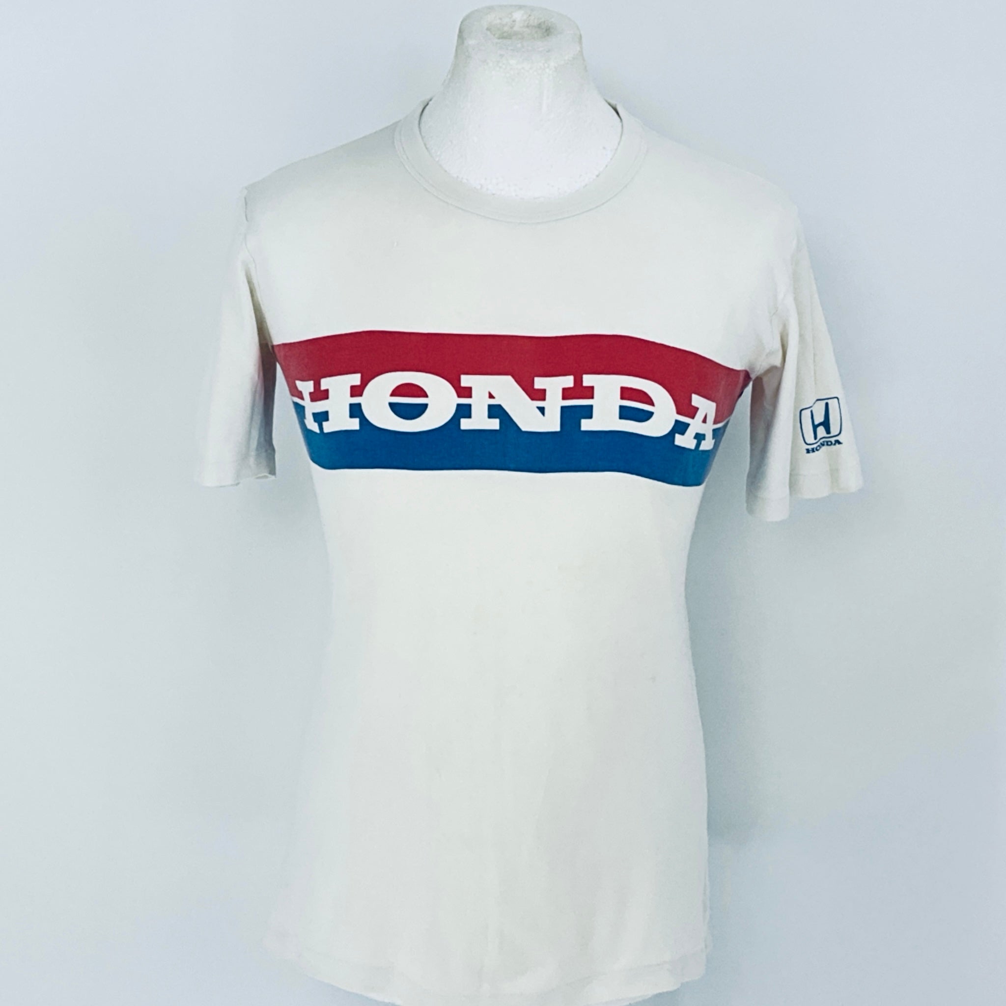 White t-shirt with red and blue Honda logo on a mannequin against a white background