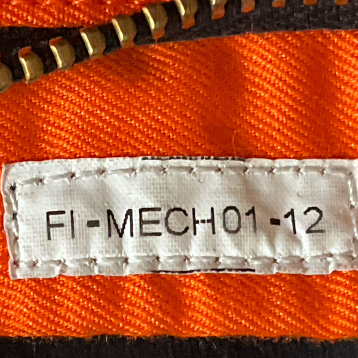 Orange racing suit label patch: FI-MECHON-12
