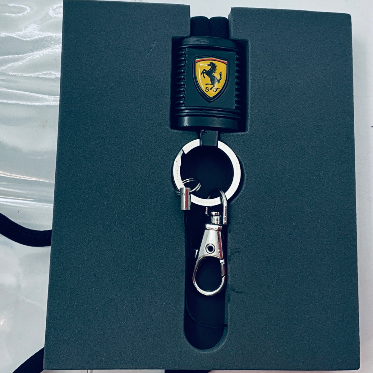 Scuderia Ferrari lanyard on dark card with black strap, shield connector, and key clip