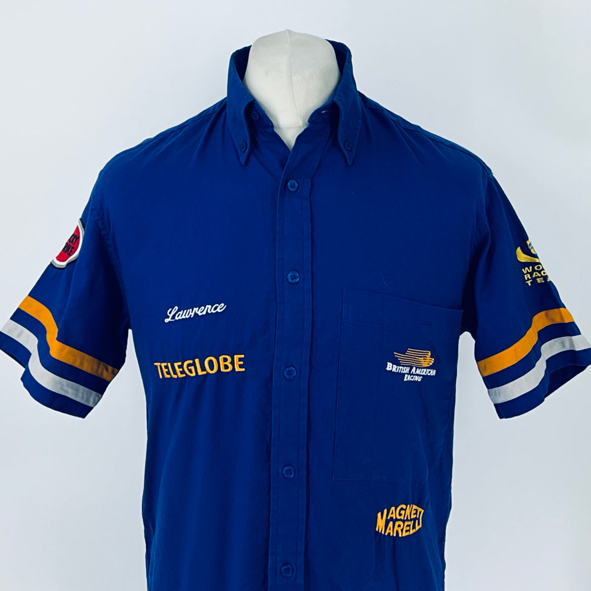 Blue button-up racing shirt front with chest logos, striped sleeves, and patch details
