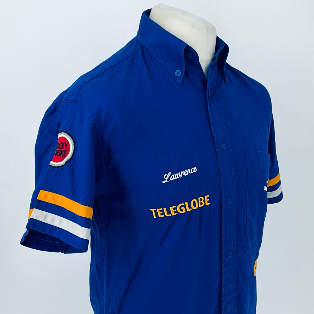 Blue short-sleeve button-up racing shirt front angled view with “Lawrence” and TELEGLOBE