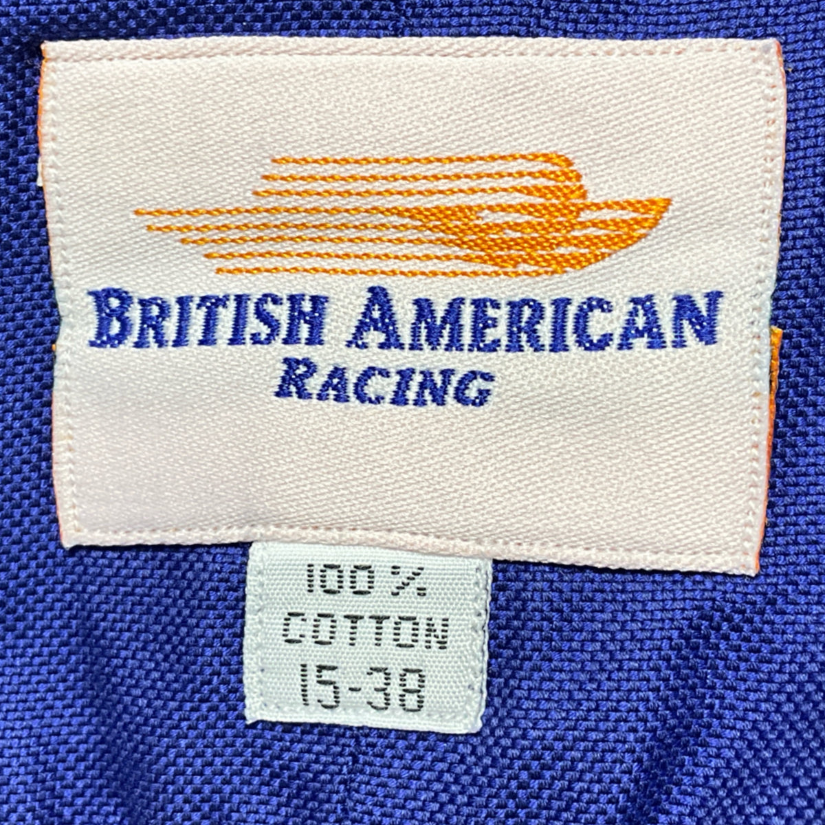 “British American Racing” label with “100% cotton” and size “15-38”