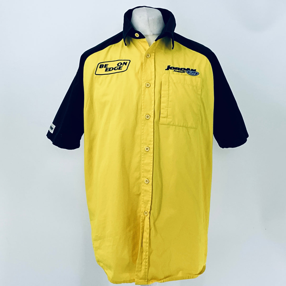 Two-tone short-sleeve button-up shirt, yellow body and navy collar with front logo patches