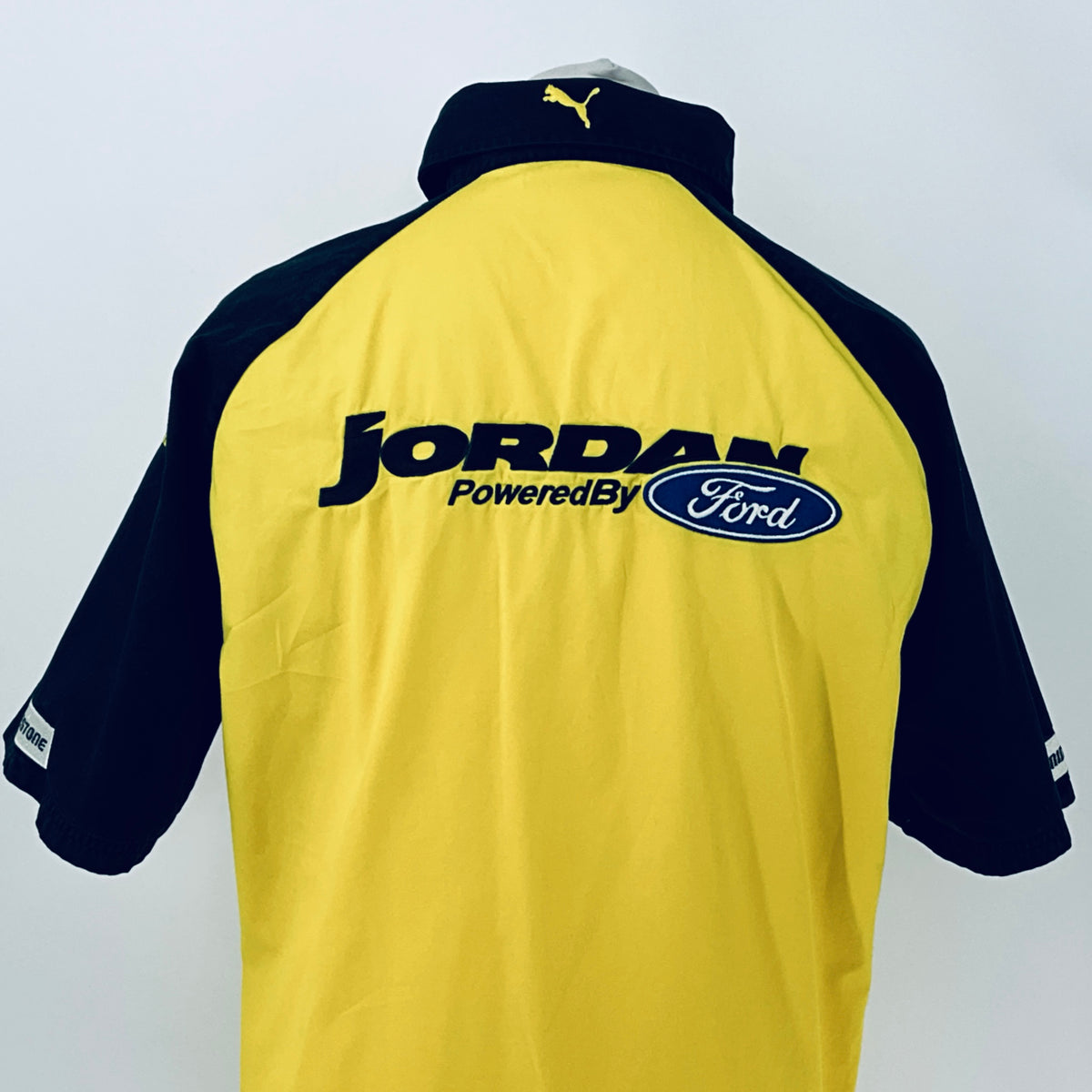 Two-tone short-sleeve button-up shirt, close back view with Jordan PoweredBy Ford logo