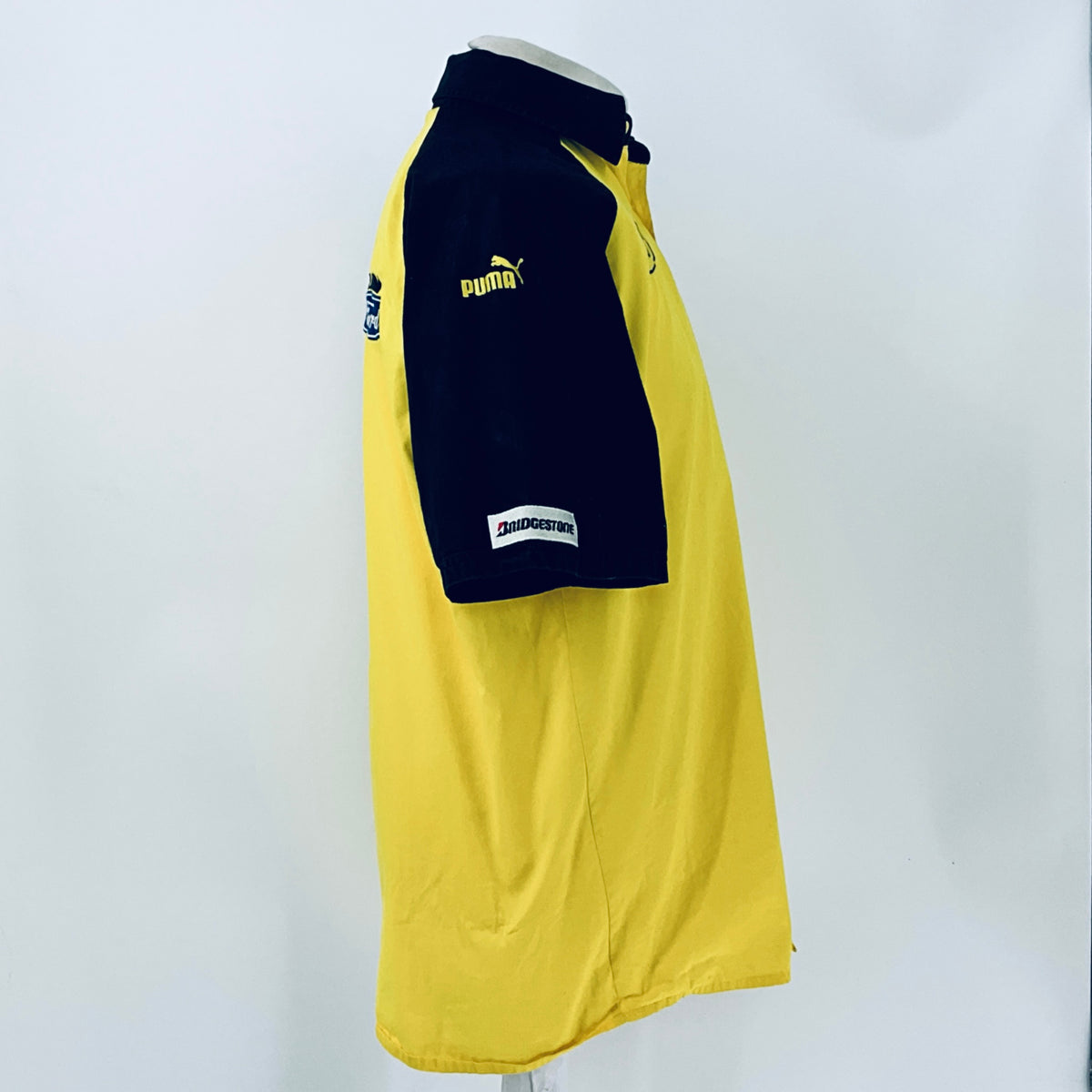 Two-tone short-sleeve button-up shirt, side view with Puma logo and sleeve patch