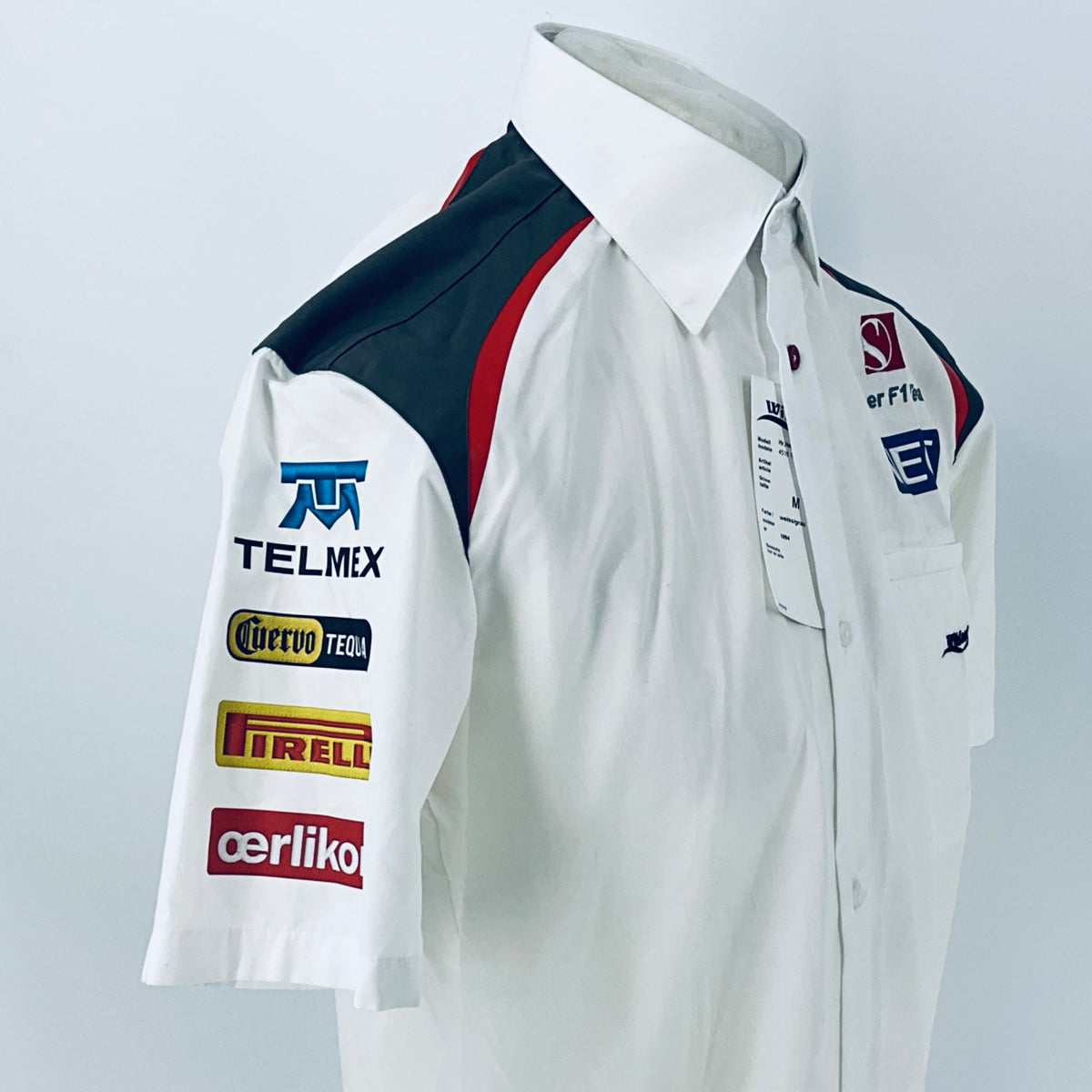 White racing shirt close side view with TELMEX, Tequila, and Pirelli patches