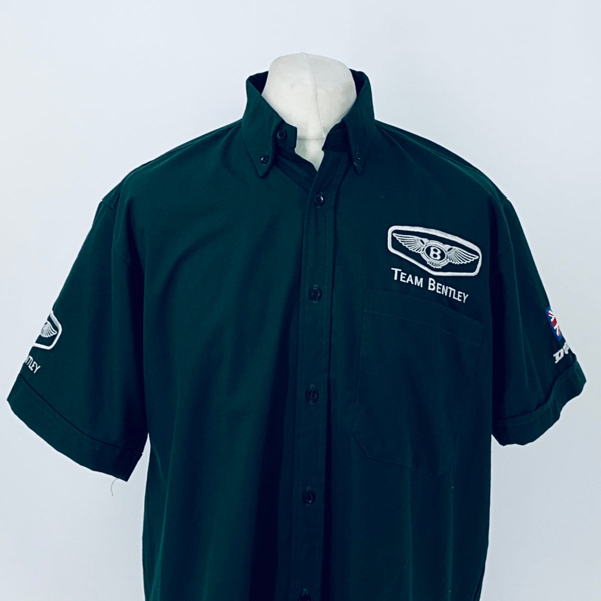 Dark teal polo shirt with Team Bentley chest patch and short sleeves