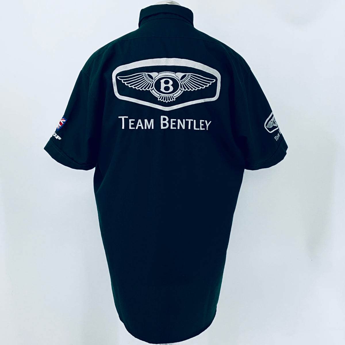 Dark teal polo shirt back with large winged Bentley emblem and Team Bentley text