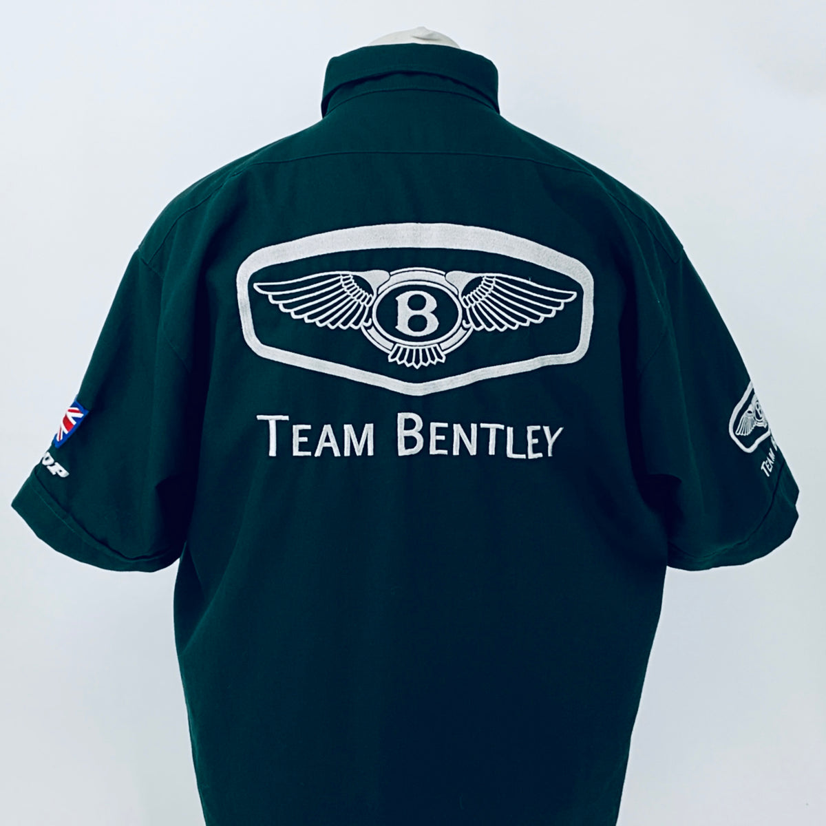 Dark teal polo shirt back with winged Bentley emblem and Team Bentley lettering