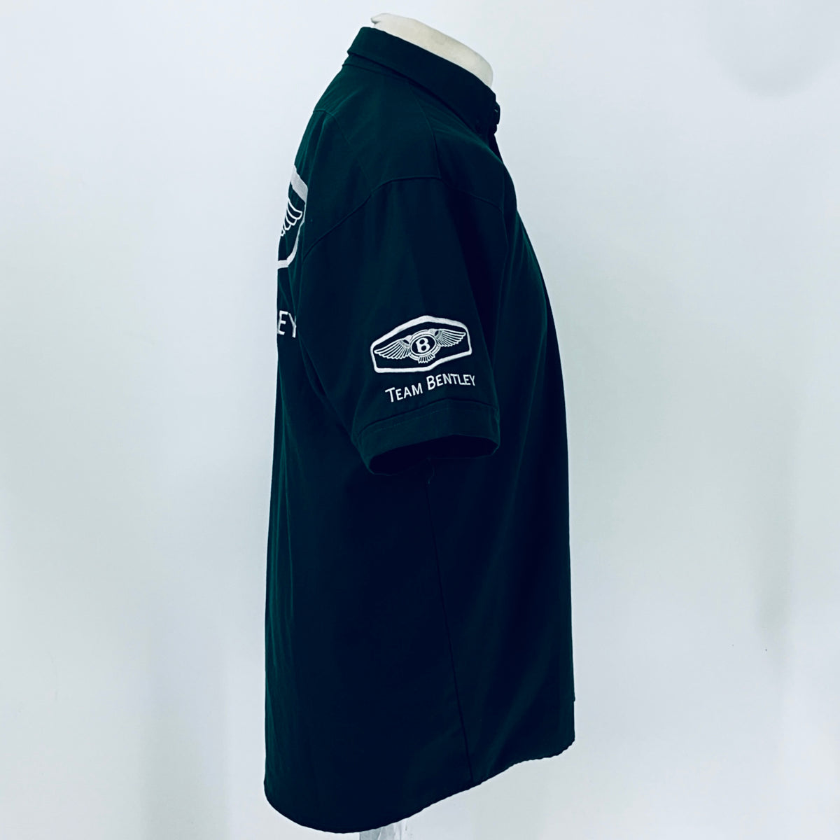 Dark teal polo shirt with Team Bentley chest logo and side profile view