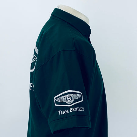 Dark teal polo shirt side view with Team Bentley patch on sleeve