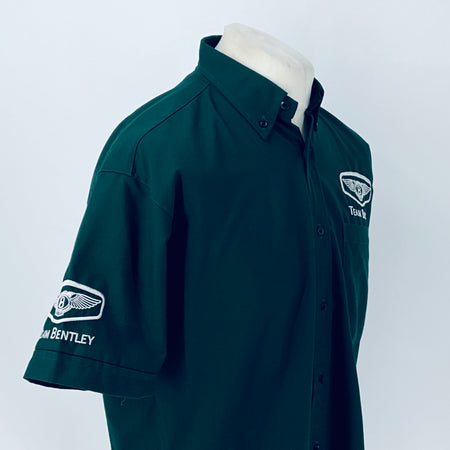 Dark teal polo shirt with button placket and Team Bentley emblem on sleeve