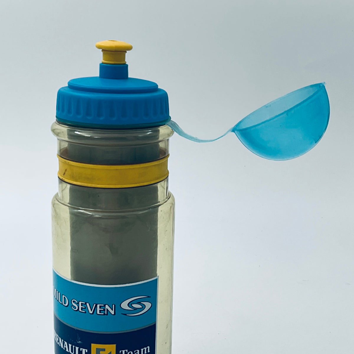 Clear bottle with blue flip spout, yellow ring, and racing logo label