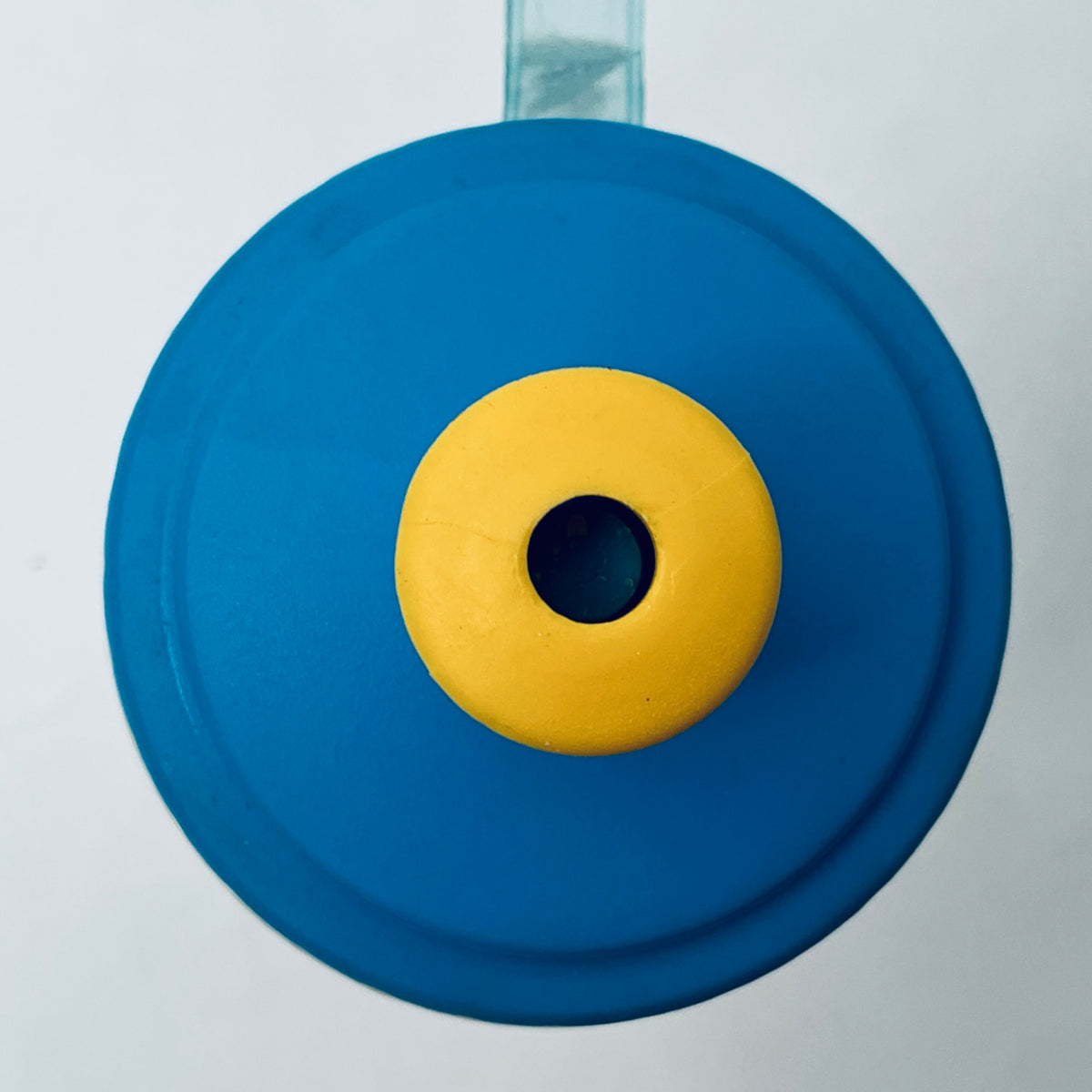 Blue bottle cap with yellow center insert