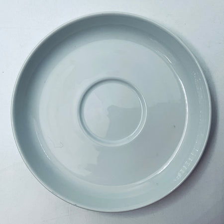 Light blue porcelain cup bottom view with glossy circular design