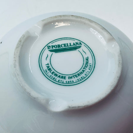 Close-up of green L'PORCELLANA tableware international backstamp on base