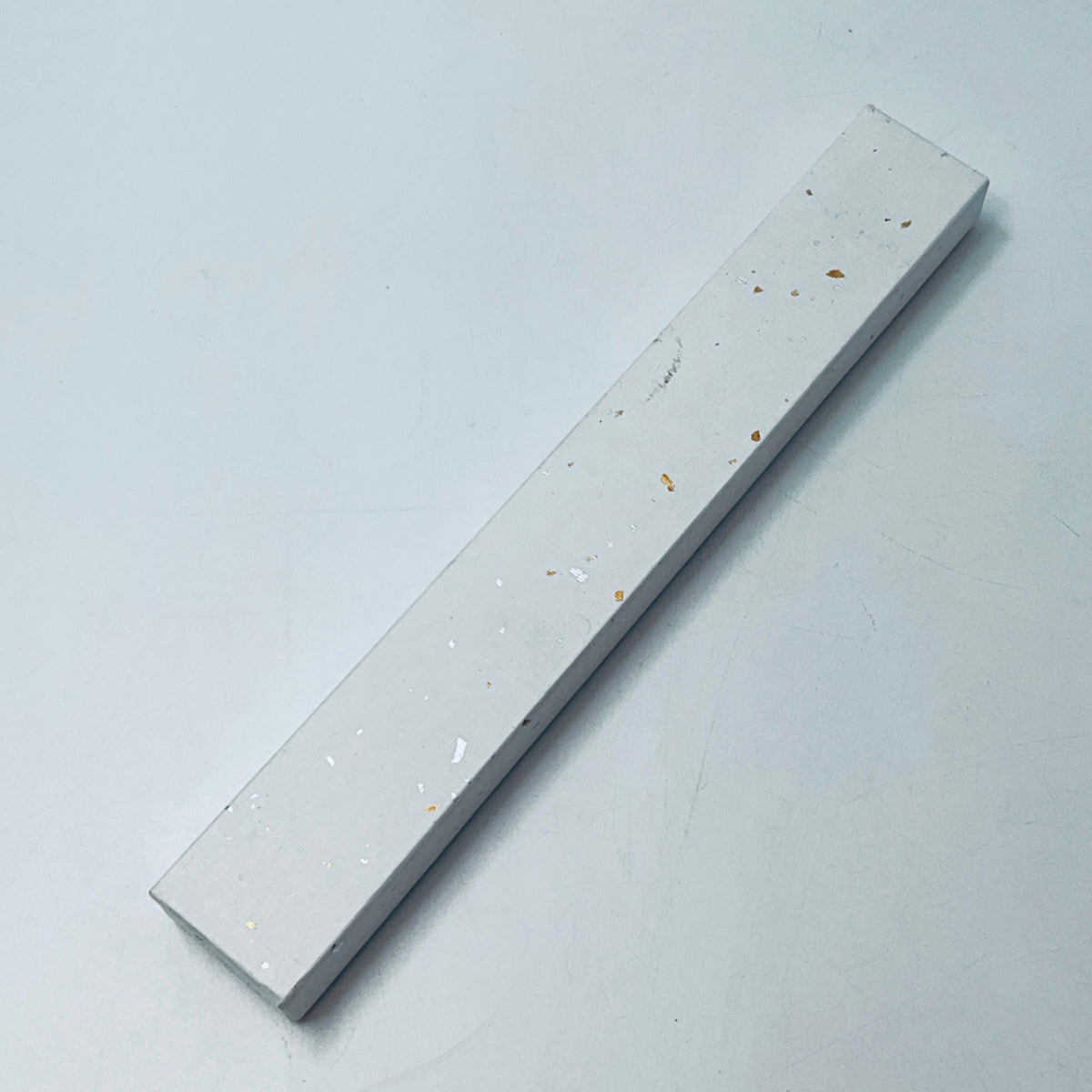 Slim gray gift box for folding fan, speckled with small gold and orange marks