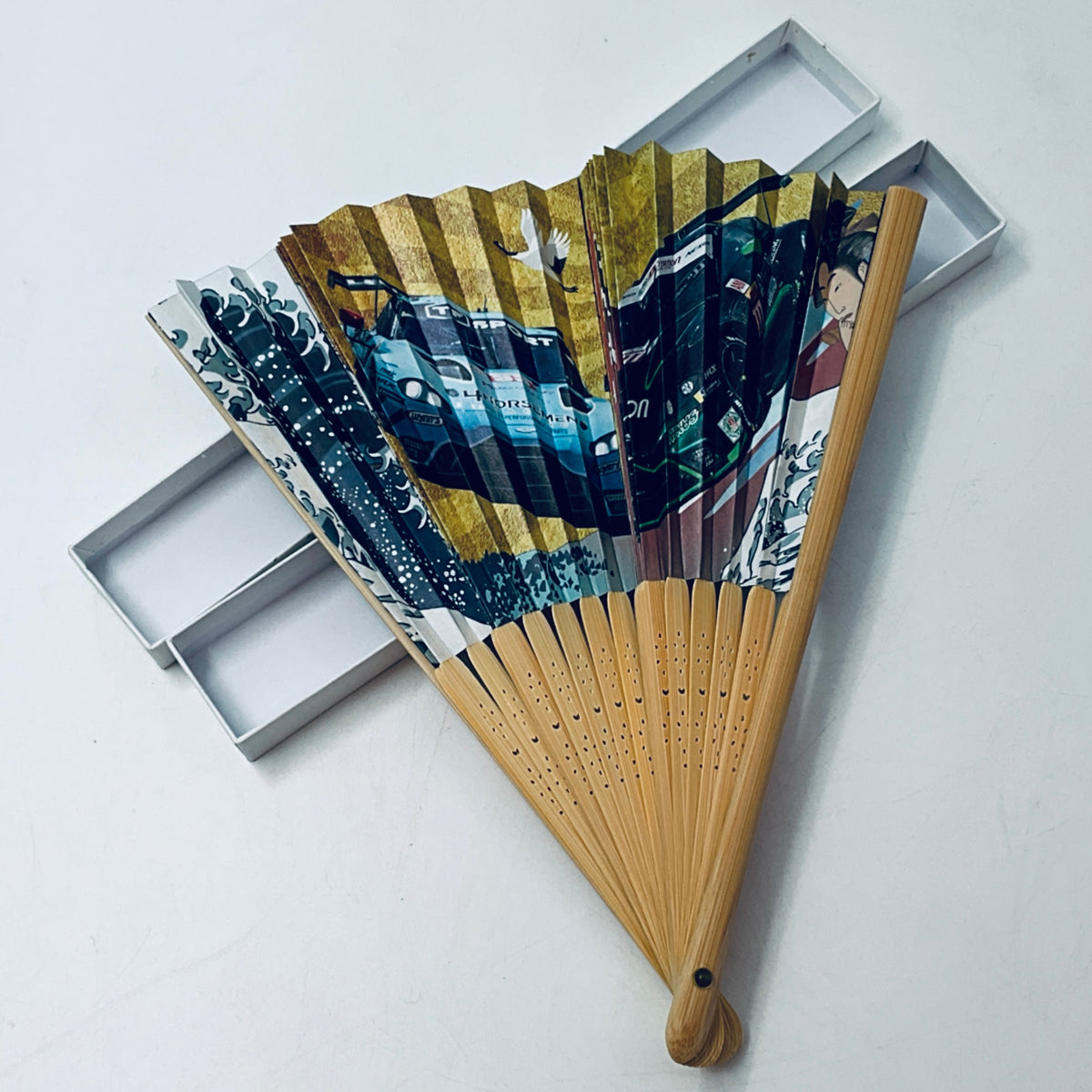 Decorative folding fan with wooden handle, blue and gold printed fan blades, in box