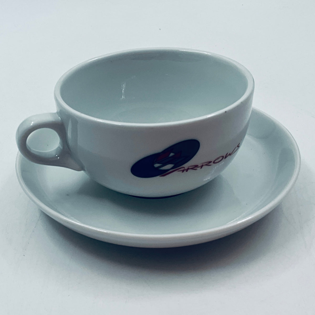 Light blue porcelain cup and matching saucer with ARROWS logo
