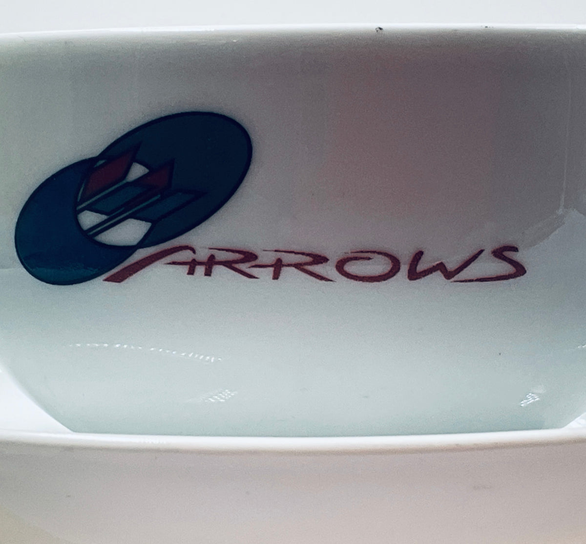 Light blue porcelain cup with ARROWS logo printed near the base